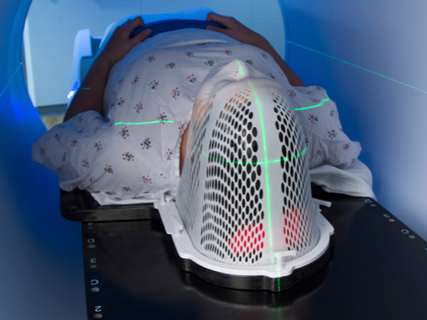 someone going through radiation machine