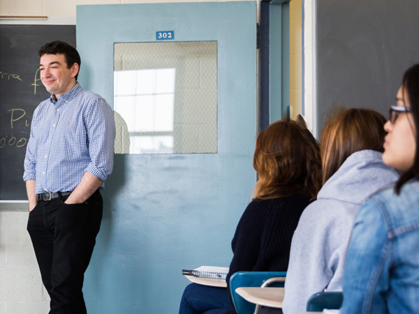 Spanish teacher in front of classroom